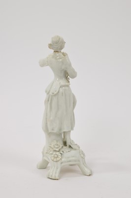Lot 30 - Lowestoft white glazed figure of a female lute player