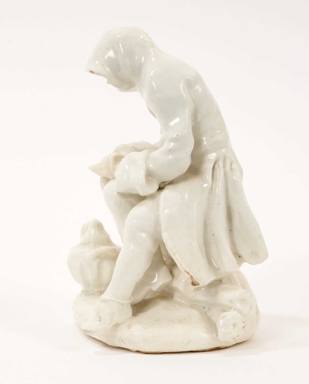 Lot 39 - Bow white glazed porcelain figure of a man before a brazier emblematic of winter, probably Longton Hall