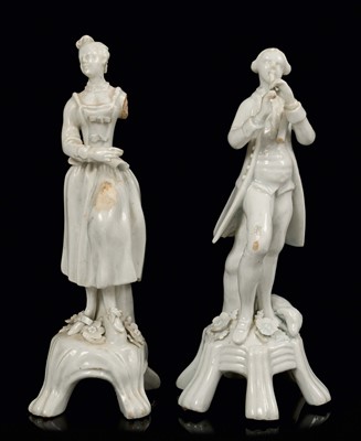 Lot 29 - Near pair of 18th century Lowestoft white glazed porcelain figures of musicians, with losses