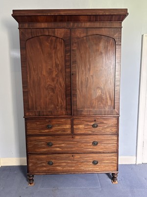 Lot 1392 - George III mahogany linen press, with hanging space above two short and three long drawers, on turned feet