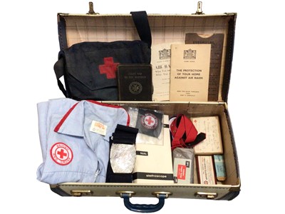 Lot 313 - Vintage suitcase containing British Red Cross related items including a uniform