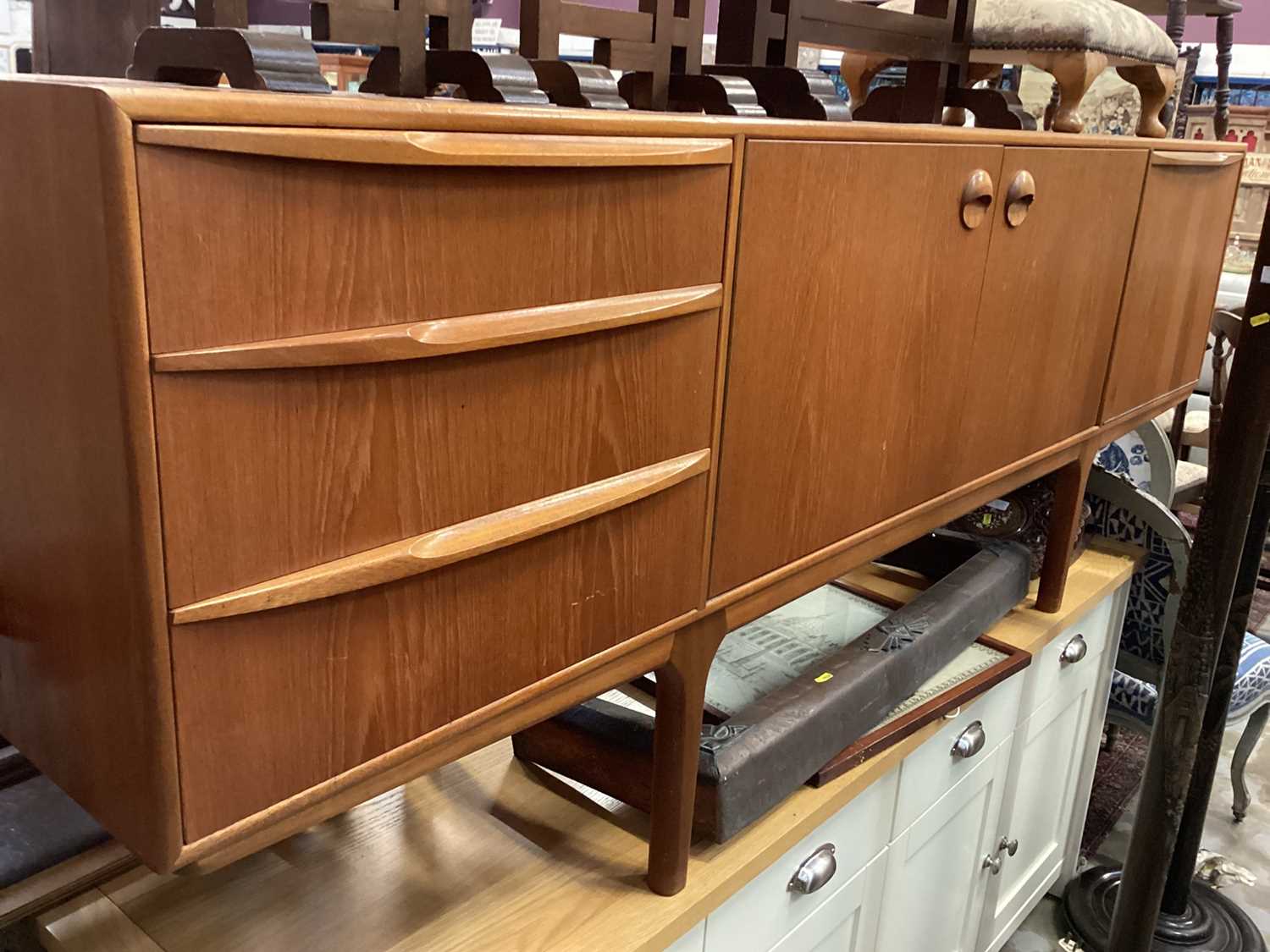 Lot 1234 - Mid century McIntosh teak sideboard with three drawers and cupboards, 205cm wide, 43.5cm deep, 75cm high