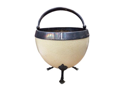 Lot 336 - Ostrich egg sugar bowl with a plated liner, swing handle and three hoof feet