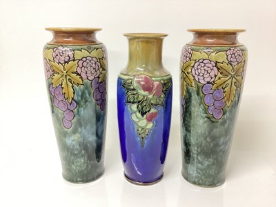 Lot 1260 - Pair of Royal Doulton vases with fruit and leaf decoration and another similar (3)