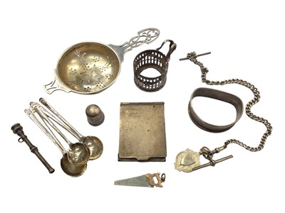 Lot 1040 - Small group of silver to include a tea strainer, five coffee spoons, matchbook holder, napkin ring and other items