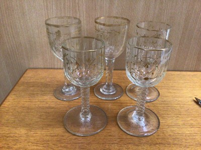 Lot 105 - Set of five Georgian facet cut wine glasses with gilt swag decoration