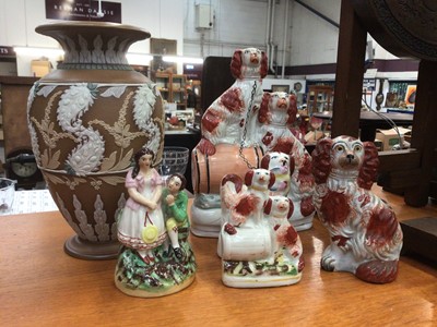 Lot 655 - Victorian Staffordshire dog related pieces, larger piece - two dogs on barrel, small - dogs on barrel, small - standing dog, seated dog, small - Staffordshire courting couple