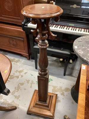 Lot 1296 - Mahogany torchere with circular top on turned and block column and square base