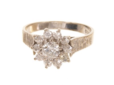 Lot 515 - Diamond cluster ring with a flower head cluster of diamonds