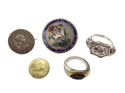 Lot 1050 - Georgian crown with enamel decoration and brooch fitting, one other coin brooch, a reproduction coin, reproduction Roman ring with carved intaglio and one other seal ring (5)