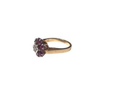 Lot 28 - 18ct gold ruby and diamond flower head cluster ring