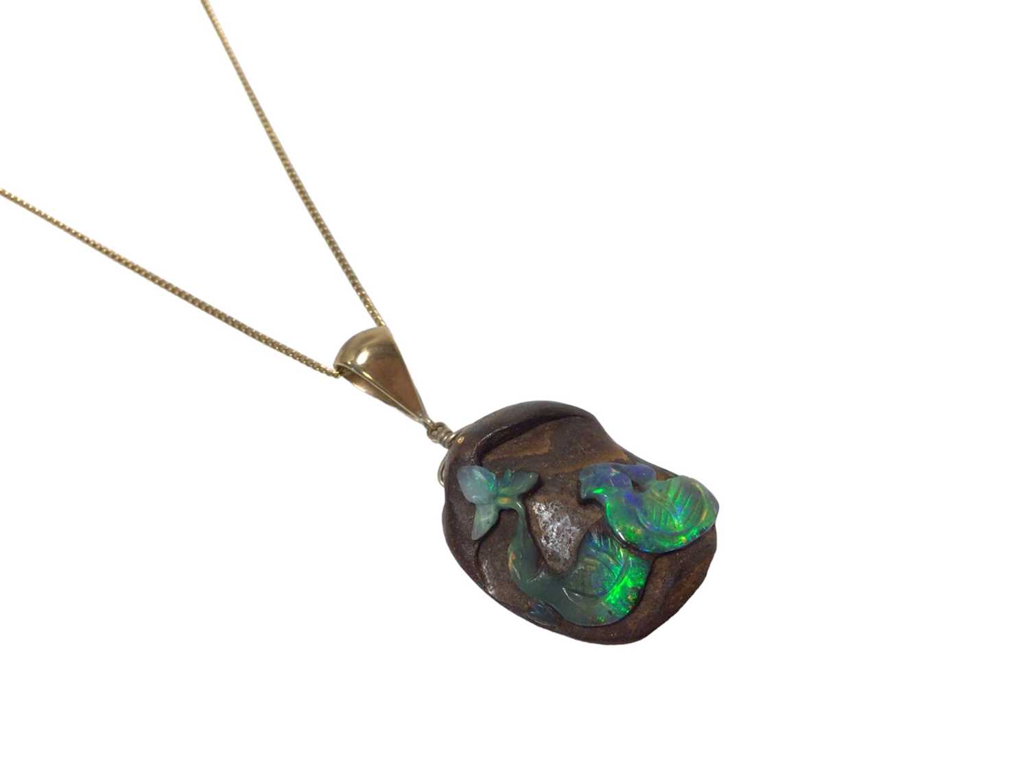 Lot 579 - Carved black opal pendant on chain