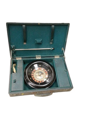 Lot 2431 - Vintage roulette wheel in leather case with counters and rake, retailed by Harrods