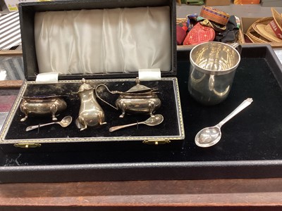 Lot 1081 - Three piece silver cruet set in fitted case, together with a silver christening mug and teaspoon.