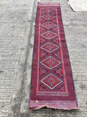 Lot 1436 - Persian runner with seven medallions on red ground, 250cm x 56cm