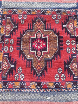 Lot 1437 - Eastern rug with central medallion on red and blue ground, 133cm x 83cm