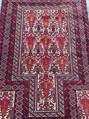 Lot 1441 - Baluch rug with geometric decoration on red ground, 144cm x 93cm