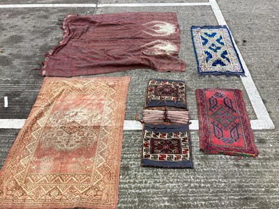 Lot 1449 - Box of small rugs and a saddle bag