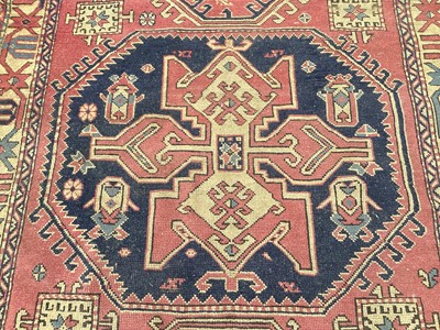 Lot 1450 - Eastern rug with geometric decoration on red and blue ground, 230cm x 148cm