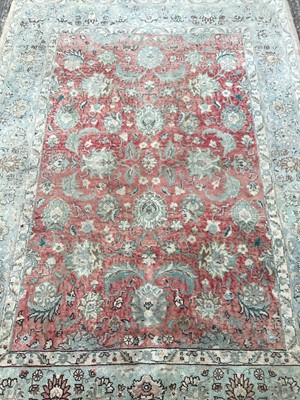 Lot 1451 - Rug with floral decoration on red and pale blue ground, 200cm x 145cm