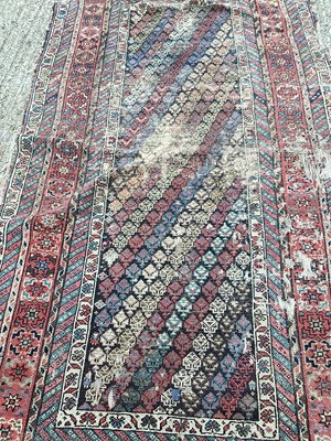 Lot 1452 - Eastern rug with geometric decoration on red ground, 240cm x 124cm