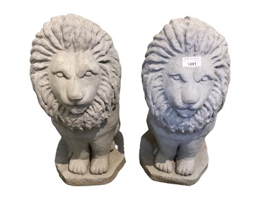 Lot 1491 - Pair of grey painted concrete garden statues of lions, 50cm high