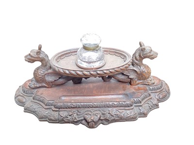 Lot 384 - Impressive late Victorian carved oak gothic inkstand, globular cut glass inkwell, on dished oval platform raised on griffin supports and stepped shaped plinth base, 54cm wide