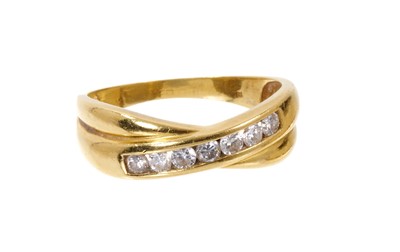 Lot 554 - Diamond 18ct gold cross over ring