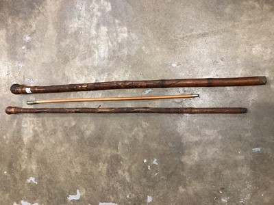 Lot 758 - Two late 19th century Japanese carved bamboo walking sticks, one with bone inlay, together with a Royal Artillery swagger stick (3)