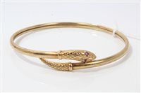 Lot 3206 - Gold (9ct) snake torque bangle with ruby eyes