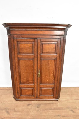 Lot 1402 - George III oak hanging corner cupboard with panelled doors