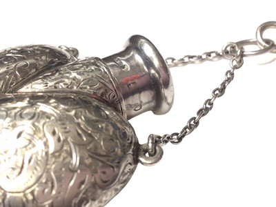 Lot 2 - Late Victorian silver heart shaped scent bottle with engraved foliate decoration by Sampson Mordan, on a long silver rope twist chain