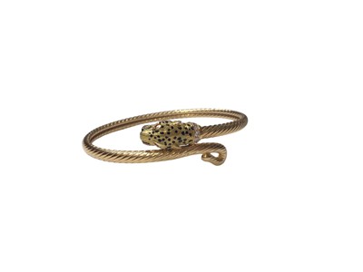 Lot 121 - 18ct gold torque bangle with leopard head terminal, black enamel spot decoration, a pair of ruby eyes and a diamond set collar