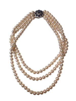 Lot 122 - Cultured pearl three strand necklace on a 9ct white gold diamond and sapphire cluster clasp