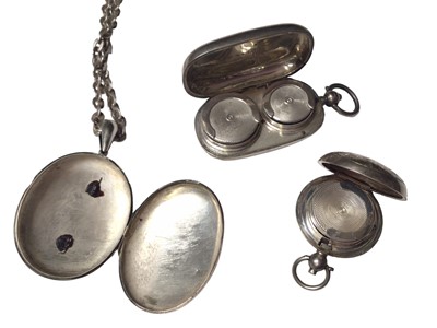Lot 50 - Victorian white metal oval locket with applied monogram on a later silver chain, together with two antique silver sovereign cases (3)