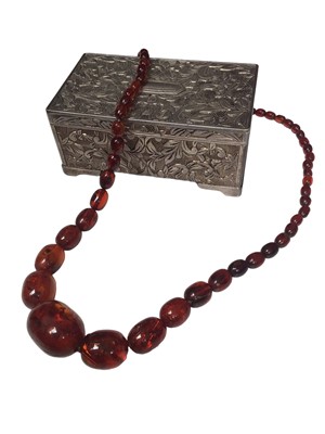 Lot 244 - Vintage amber bead necklace with graduated oval polished beads, within a silver plated jewellery box