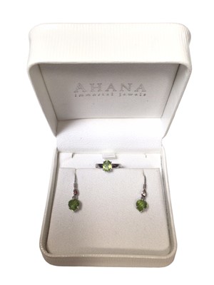 Lot 55 - 18ct white gold peridot ring and a similar pair of earrings