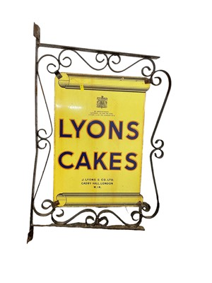 Lot 2442 - Original Lyons Cakes enamel sign mounted in wrought iron bracket, the sign 54.5cm x 36.5cm