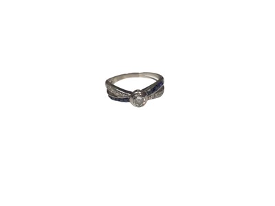 Lot 153 - Diamond single stone ring with sapphire and diamond set cross over shoulders