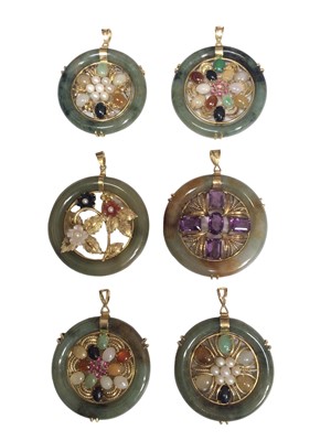Lot 167 - Six Chinese jade/ green hard stone circular gem set pendants with 14ct gold mounts