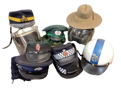 Lot 873 - Collection of Police hats, helmets and head gear to include Essex Police motorcycle helmet, (1 box).