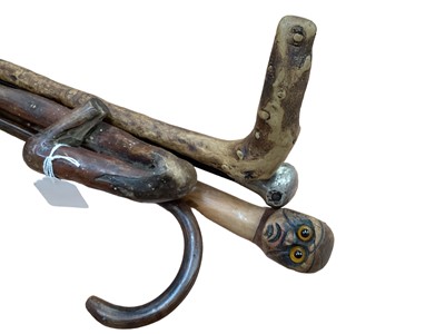 Lot 2553 - Georgian rustic walking stick dated 1835 with novelty man's head knop and glass eyes and four others (5)