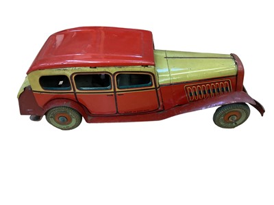 Lot 2014 - Tinplate clockwork model of a saloon car, made in England (1)
