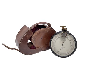 Lot 899 - Scare British military surveyors pocket measuring instrument, the silvered dial named 'Surveying Aneroid Compensated', the metal casing fitted with a winder and detachable swivel magnifying glass,...