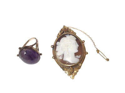 Lot 251 - Antique carved shell cameo depicting a classical female bust in a gilt metal scroll design brooch mount, together with an amethyst cabochon cocktail ring in yellow metal setting, size S