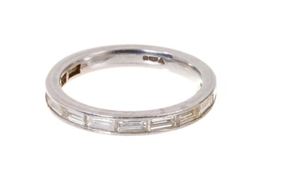 Lot 502 - Platinum and diamond eternity ring with a band of baguette cut diamonds
