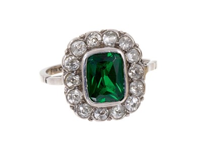 Lot 457 - 1920s diamond and green stone platinum ring