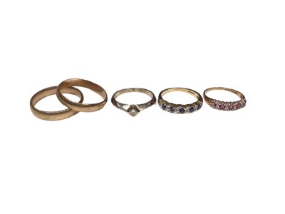 Lot 317 - Five 9ct gold rings to include a diamond single stone ring, a sapphire and diamond eternity ring, a ruby and diamond eternity ring and two gold wedding rings (5)