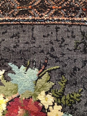 Lot 2047 - 1934 hand-embroidered wool cross stitch tapestry panel, flowers on black ground, signed E H G 1934