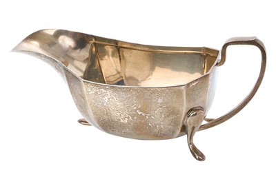 Lot 255 - Late 1940s silver sauce boat of faceted form, with angular loop handle